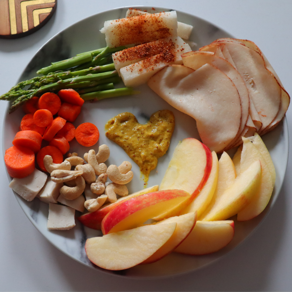 what I eat in day low carb snack plate. Apples, cashews, veggies, turkey.