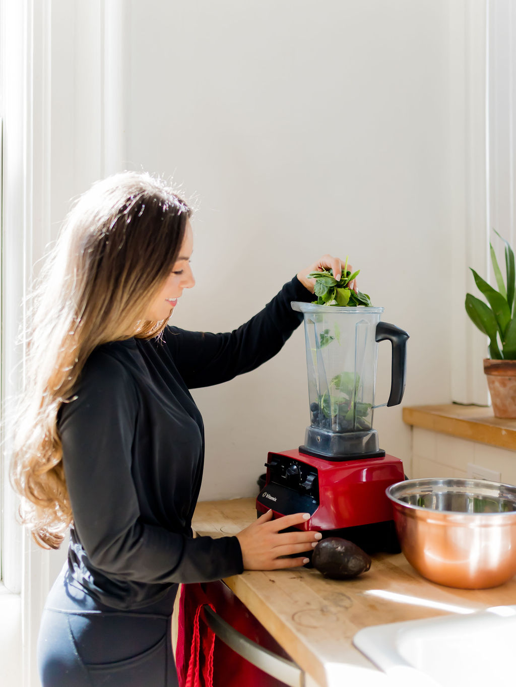 girl making protein shake for low carb snack on the go